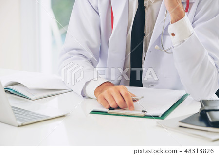 Doctor working with paperwork in the hospital. 48313826
