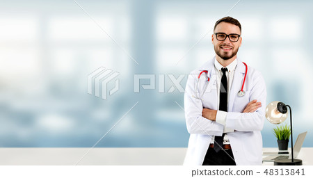 Handsome doctor standing in hospital office. 48313841