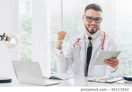 Doctor working on tablet computer in the hospital. Doctor working on tablet computer in the hospital. 48313842