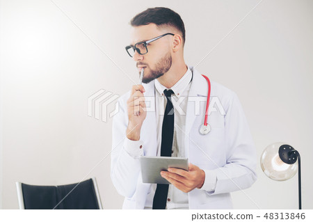 Doctor working on tablet computer in the hospital. 48313846