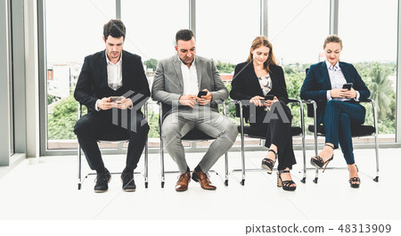 Businesswomen and businessmen using mobile phone. 48313909