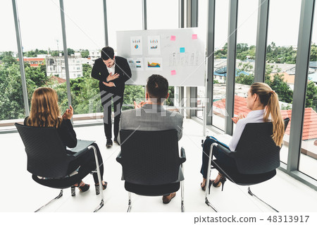 Businesswomen and businessmen in group meeting. Businesswomen and businessmen in group meeting. 48313917
