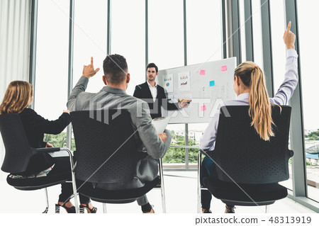 Businesswomen and businessmen in group meeting. Businesswomen and businessmen in group meeting. 48313919