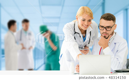 Doctor working in hospital with other doctors. Doctor working in hospital with other doctors. 48314150