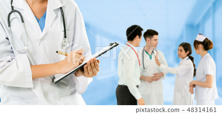 Doctor working in hospital with other doctors. Doctor working in hospital with other doctors. 48314161