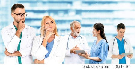 Doctor working in hospital with other doctors. 48314163