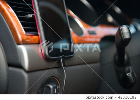 Car A/C magnet mobile phone holder in use Car A/C magnet mobile phone holder in use 48316192