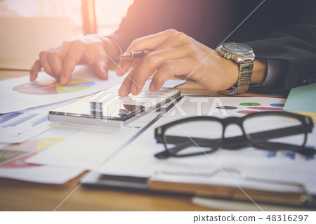 Businessman or accountant working on calculator to Businessman or accountant working on calculator to 48316297