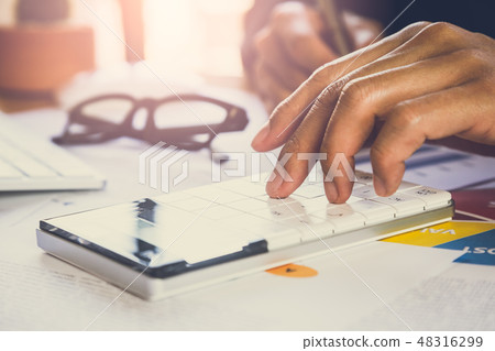 Businessman or accountant working on calculator to Businessman or accountant working on calculator to 48316299