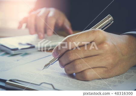Businessman or accountant working on calculator to Businessman or accountant working on calculator to 48316300