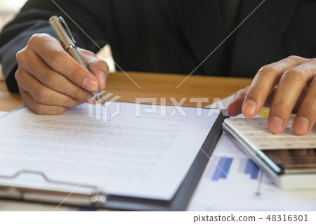 Businessman or accountant working on calculator to Businessman or accountant working on calculator to 48316301