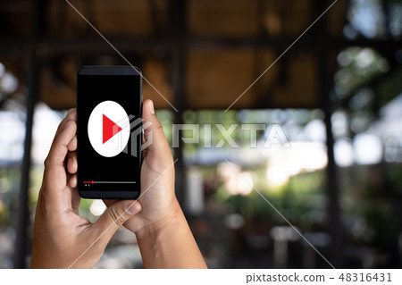 man holding smartphone against VDO ads concept 48316431