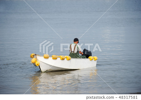 A fisherman out fishing 48317581