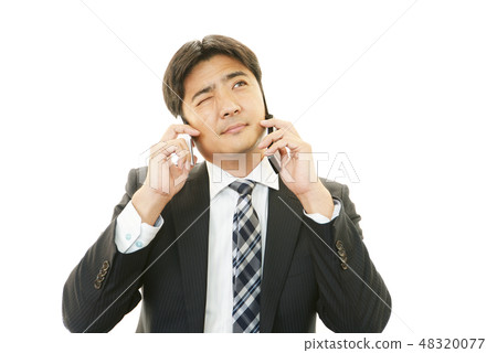 A busy businessman A busy businessman 48320077