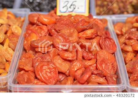 A lot of dried apricots market stall close-up 48320172