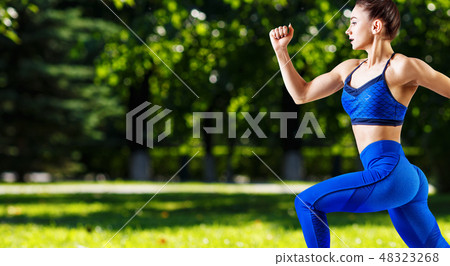 Sporty young woman jogging outdoors in the summer. Sporty young woman jogging outdoors in the summer. 48323268