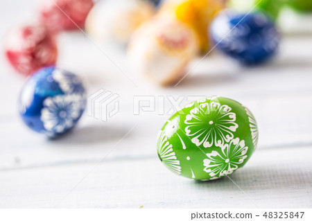 Close-up multicolored easter eggs on wooden table 48325847