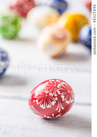 Close-up multicolored easter eggs on wooden table Close-up multicolored easter eggs on wooden table 48325848