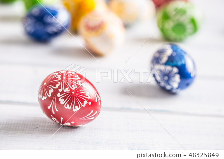 Close-up multicolored easter eggs on wooden table Close-up multicolored easter eggs on wooden table 48325849