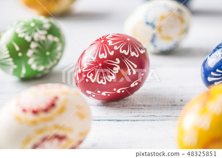 Close-up multicolored easter eggs on wooden table Close-up multicolored easter eggs on wooden table 48325851