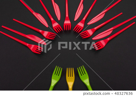 Colorful set of vibrant forks and knife isolated on black 48327636