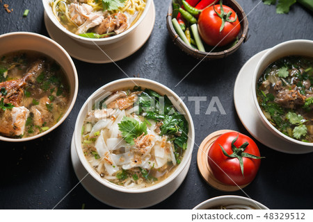 Noodles and soup. 48329512