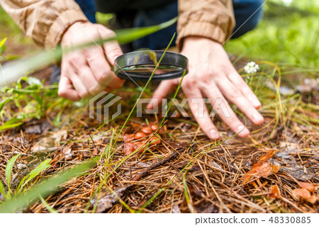 Photo of male biologist with magnifying glass 48330885