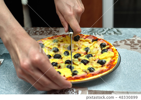 Cut into slices delicious fresh pizza with olives Cut into slices delicious fresh pizza with olives 48330899