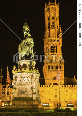 Bronze statue and bell tower of Bruges Market Square in Belgium 48331023