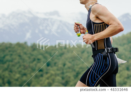 male athlete runner with energy gel in hand male athlete runner with energy gel in hand 48331646