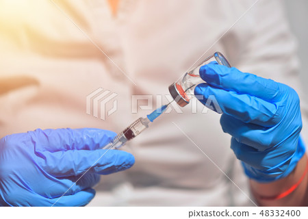 Closeup of vaccine bottle with syringe and needle Closeup of vaccine bottle with syringe and needle 48332400