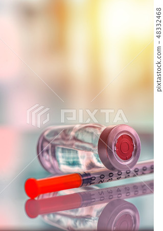 Closeup of vaccine bottle with syringe and needle Closeup of vaccine bottle with syringe and needle 48332468