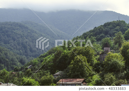Thick fog in  mountains with forest and  chapel  Thick fog in  mountains with forest and  chapel  48333883