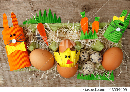 Easter eggs, rabbits and chikens on wood  48334409