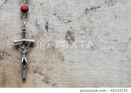 Christian rosary hanging on old canvas Christian rosary hanging on old canvas 48334545