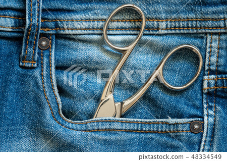 Metal scissors in blue jeans pocket 48334549