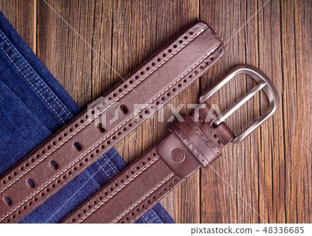 Leather belt and blue jeans Leather belt and blue jeans 48336685