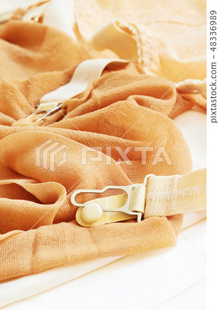 A pair of old stockings with garters A pair of old stockings with garters 48336989