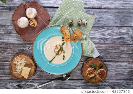 Bowl with delicious mushroom soup on wooden table Bowl with delicious mushroom soup on wooden table 48337545