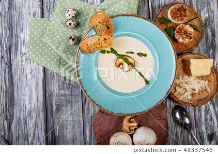 Bowl with delicious mushroom soup on wooden table Bowl with delicious mushroom soup on wooden table 48337546