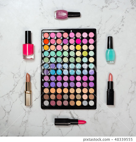 Flat lay of makeup eyeshadow palette with decorative cosmetics on marble texture Flat lay of makeup eyeshadow palette with decorative cosmetics on marble texture 48339555