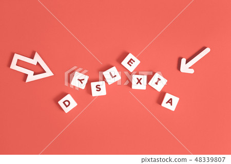 Dyslexia word and arrows on coral background 48339807
