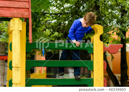 Funny children play on a children's playground 48339905