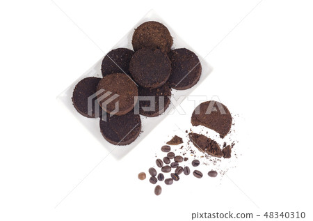 Pressed waste coffee beans on white background Pressed waste coffee beans on white background 48340310