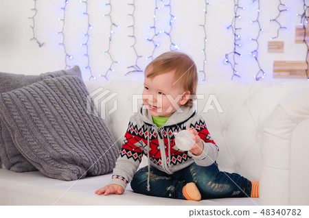 Cute little boy is sitting on the couch at home 48340782