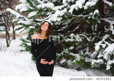 Detail of unrecognizable pregnant woman's belly in winter 48341981