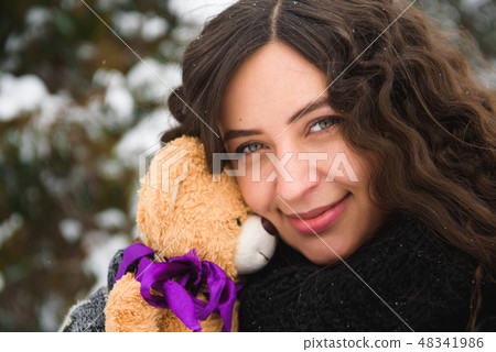 Happy young woman walking in winter time Happy young woman walking in winter time 48341986