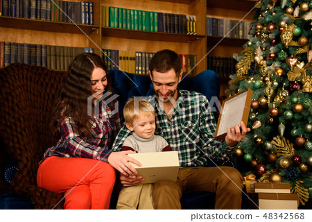 Christmas Family Open Present Gift Bag, Looking to Magic Light in Night Xmas Tree Interior. 48342568
