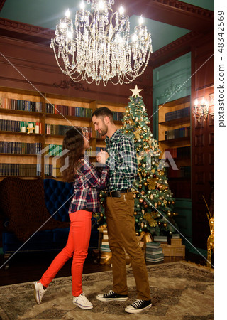 Merry Christmas. Young couple celebrating Christmas at home 48342569