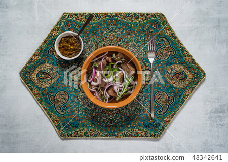 Mutton pieces stewed in a pot. Top view.  48342641